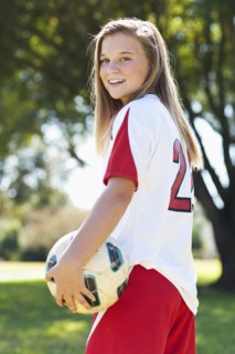 Caucasian soccer player holding ball