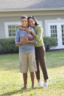 Mother and son hugging in backyard