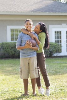 Mother and son hugging in backyard