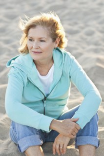 Caucasian woman sitting on beach