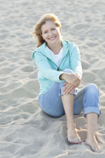 Caucasian woman sitting on beach