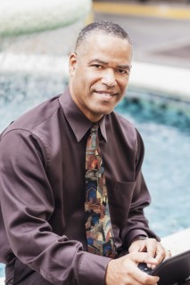 African American businessman working at fountain