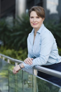 Caucasian businesswoman leaning on banister outdoors