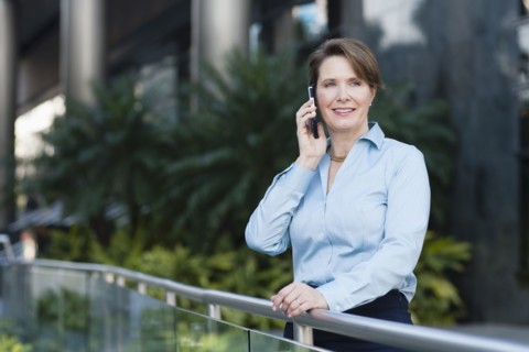 Caucasian businesswoman talking on cell phone outdoors
