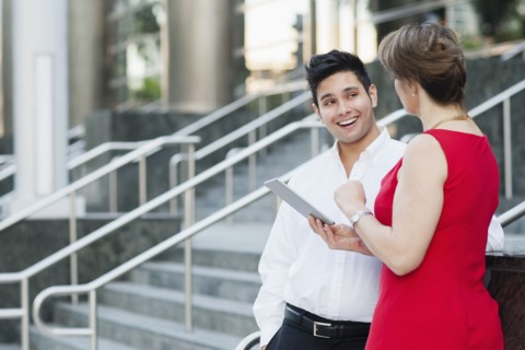 Business people using digital tablet near staircase