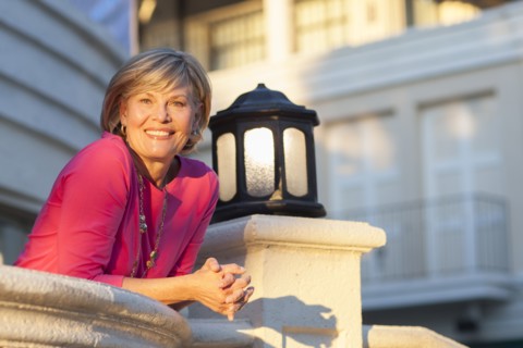 Caucasian woman leaning over balcony