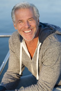 Caucasian man smiling on boat deck