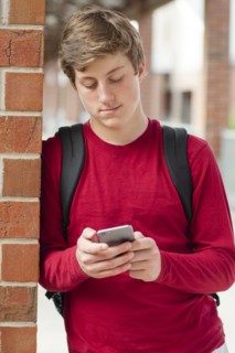 Caucasian teenage boy using cell phone