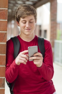 Caucasian teenage boy using cell phone