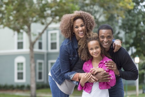 Family smiling outdoors