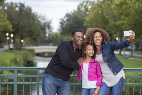 Family taking selfie on bridge