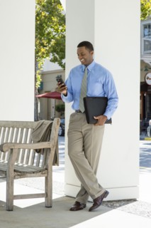 Black businessman using cell phone outdoors