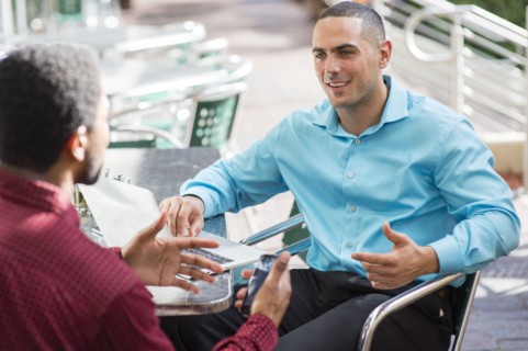 Businessmen talking in cafe