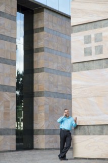 Caucasian businessman talking on cell phone outdoors