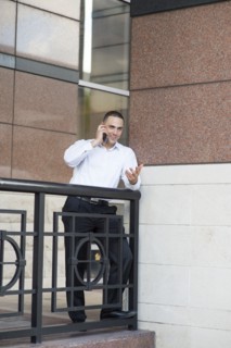 Caucasian businessman talking on cell phone outdoors