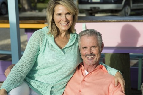 Older Caucasian couple hugging outdoors