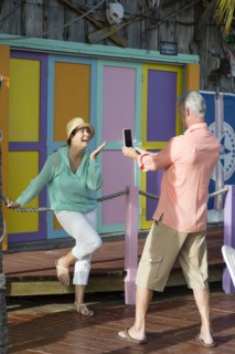 Older Caucasian man photographing wife