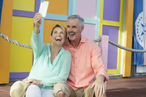 Older Caucasian couple taking selfie