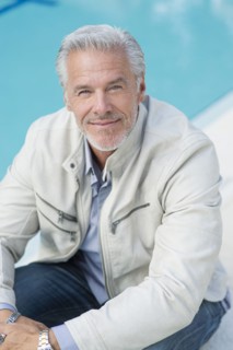 Caucasian man sitting poolside