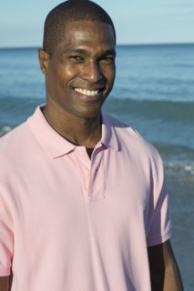 Portrait of smiling Black man on beach