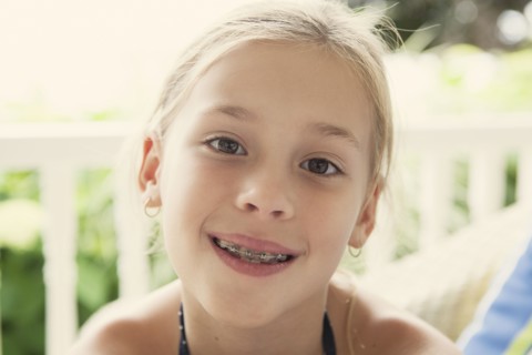 Caucasian girl smiling with braces