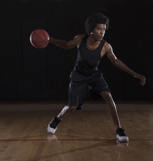 African American man playing basketball on court