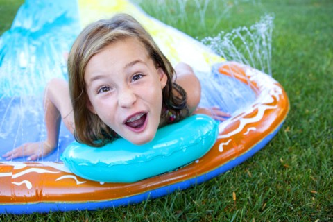 Caucasian girl smiling on water slide