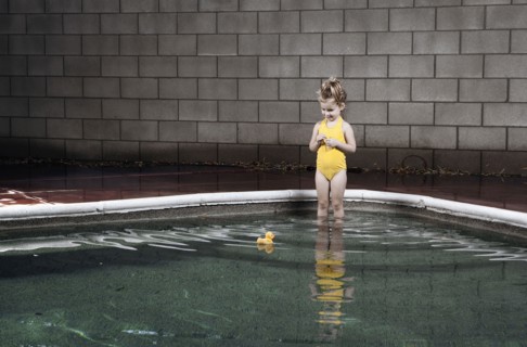 Caucasian girl standing in swimming pool