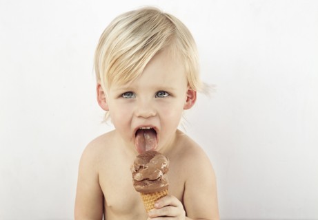 Caucasian boy licking chocolate ice cream cone