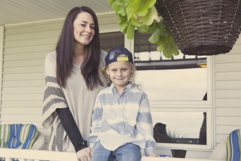 Caucasian mother and son smiling on porch