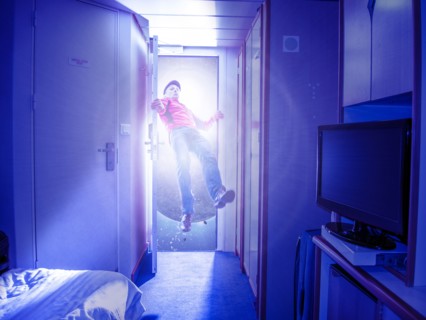 Caucasian man flying in bedroom