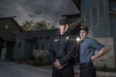 Caucasian security officers posing with flashlight