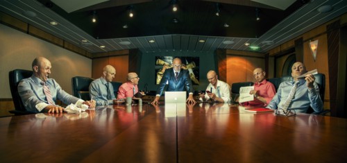 Multiple exposure of Caucasian businessmen in conference room