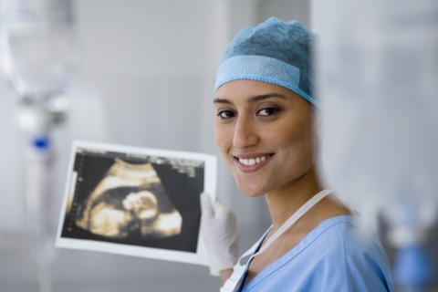 Female doctor holding sonogram