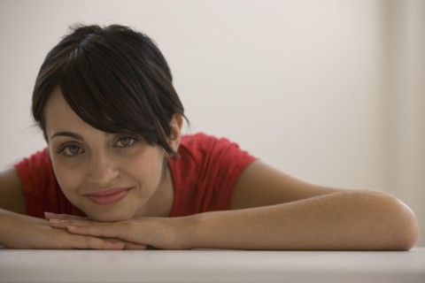 Young woman resting chin on hands