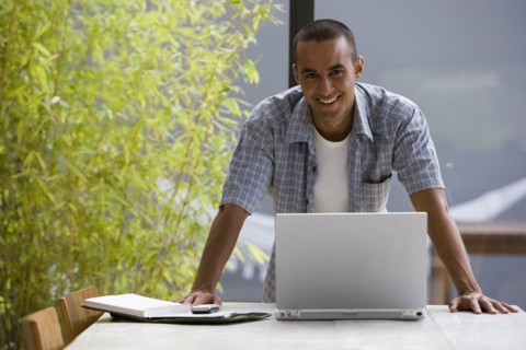 Portrait of young man with laptop