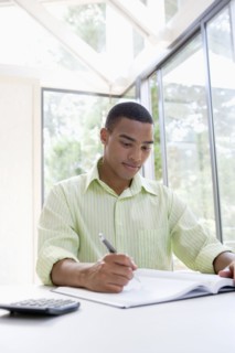 African man writing in notebook