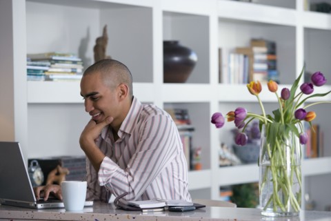 African American man looking at laptop