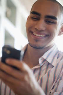 African American man looking at cell phone