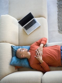 African American man sleeping on sofa