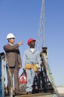 Multi-ethnic businessman and construction worker walking