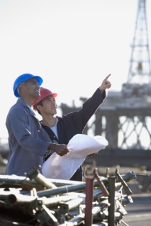 Multi-ethnic male construction workers pointing
