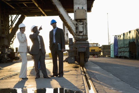 African American businesspeople wearing hardhats