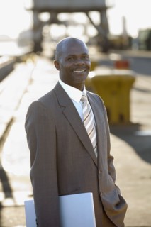 African American businessman holding laptop