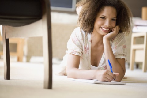African woman writing on note pad