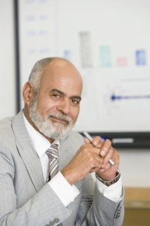 Senior African businessman holding pen