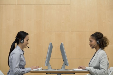 Multi-ethnic businesswomen wearing headsets