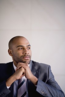 African businessman resting chin on hands