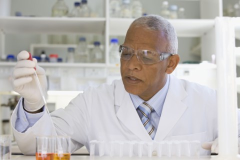 African scientist performing analysis in laboratory
