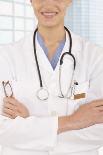 Mixed race doctor with arms crossed in hospital